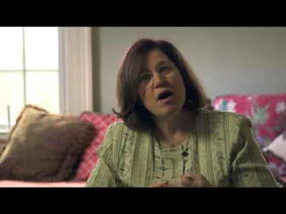 white woman in green shirt talking about what to ask about breast reconstruction