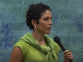 woman in green speaking 
