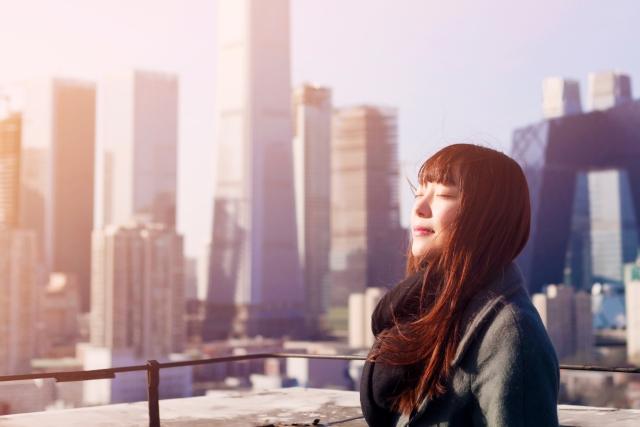 woman in a sunny cityscape