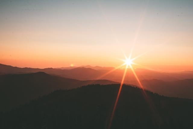 landscape of sunrise over large hills