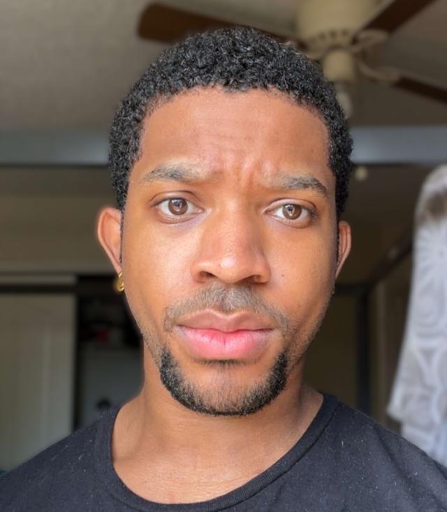 A headshot photo of Daniel