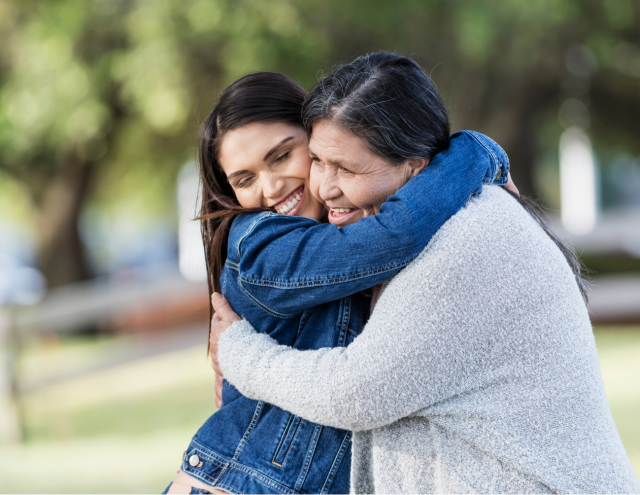 two women hugging outside