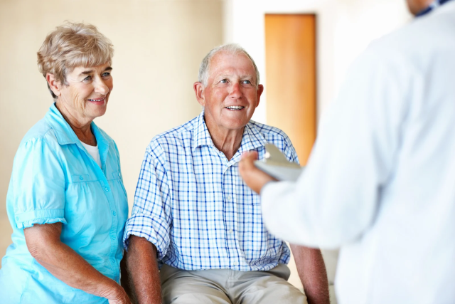 Doctor talking to senior couple