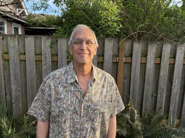 Jeffrey smiles in a backyard setting