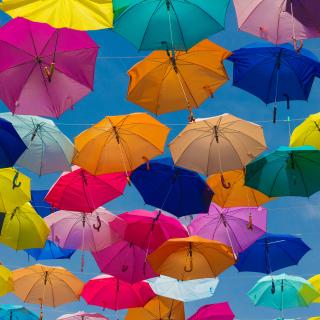 Colorful umbrellas strung up in the sky