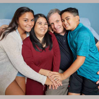 joe and his family smiling
