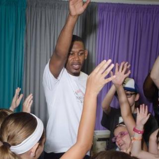 Middleweight boxing champion Daniel Jacobs interacts with a group of children