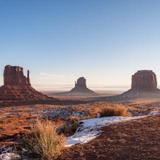 Red sandstone buttes under a blue sky in Monument Valley on the Navajo Nation 