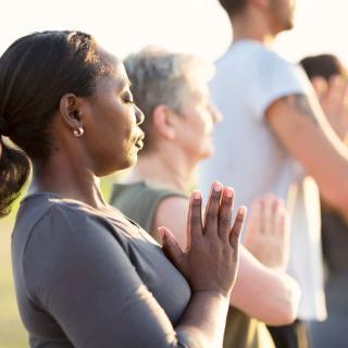women and men practicing yoga
