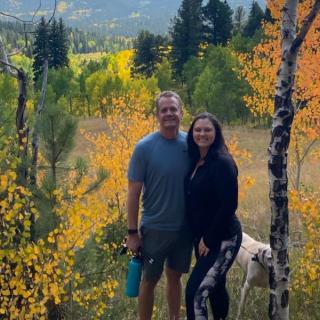 Amber and her husband enjoy the autumn colors on a mountain hike with their dog.