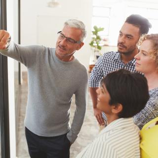 A man presenting ideas to a group of other adults