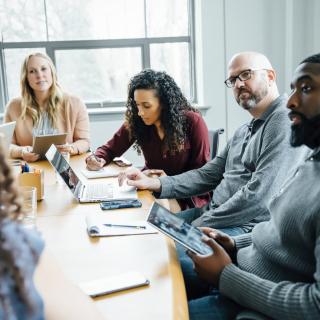 A seated group of talking men and women 