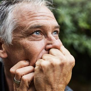 white man contemplating with hands under chin