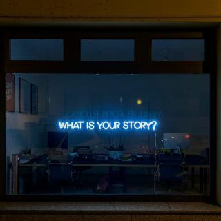 What Is Your Story? display LED lights in office window