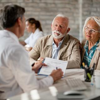 Senior couple consulting with doctor