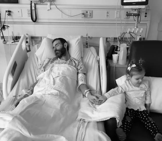 Ash in hospital bed with young daughter