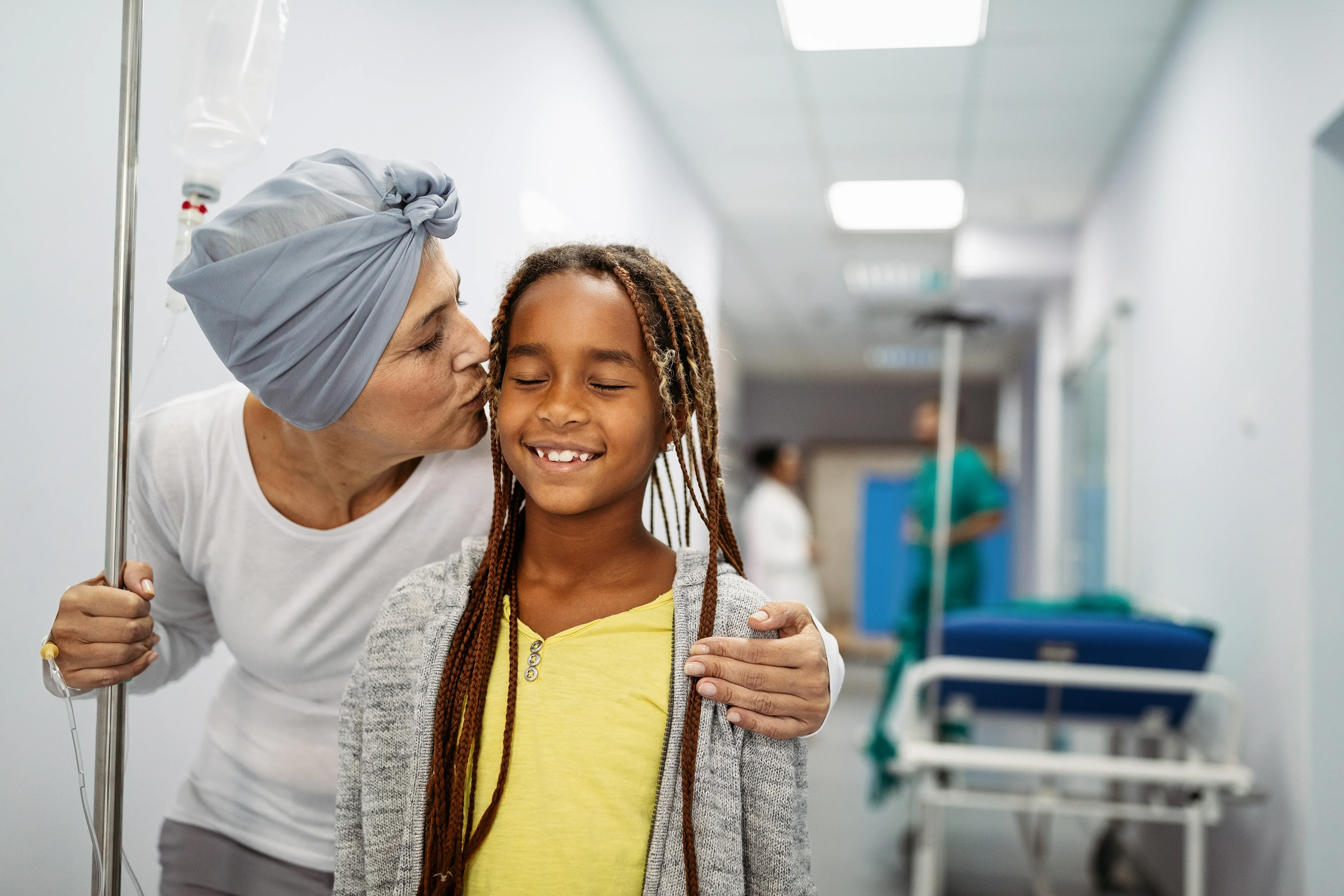 woman kissing a young girl