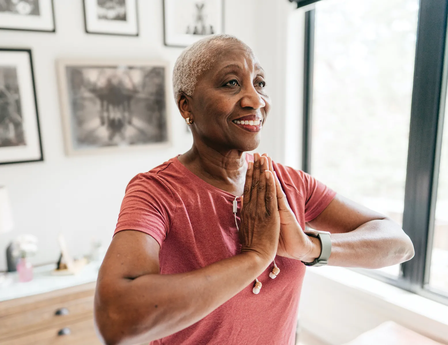 Senior women taking care of her wellbeing, she is exercising at home in sportswear