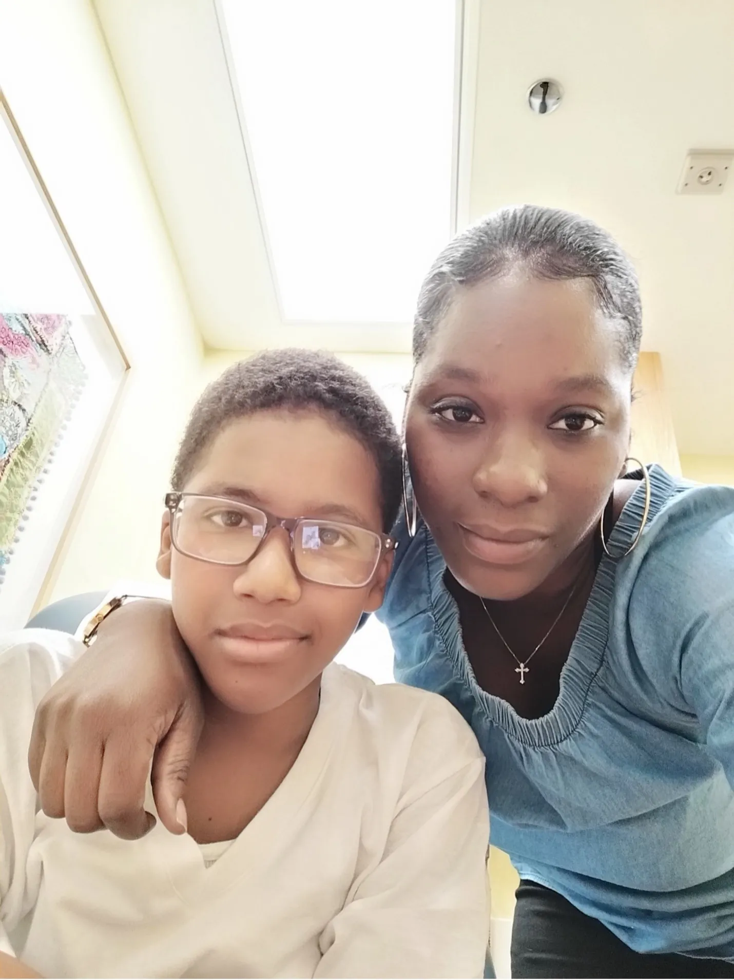 A mother with her arm around her son