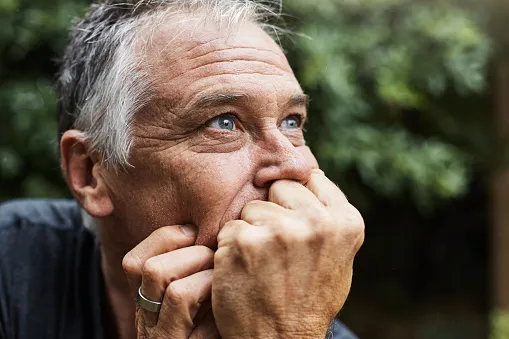 white man contemplating with hands under chin
