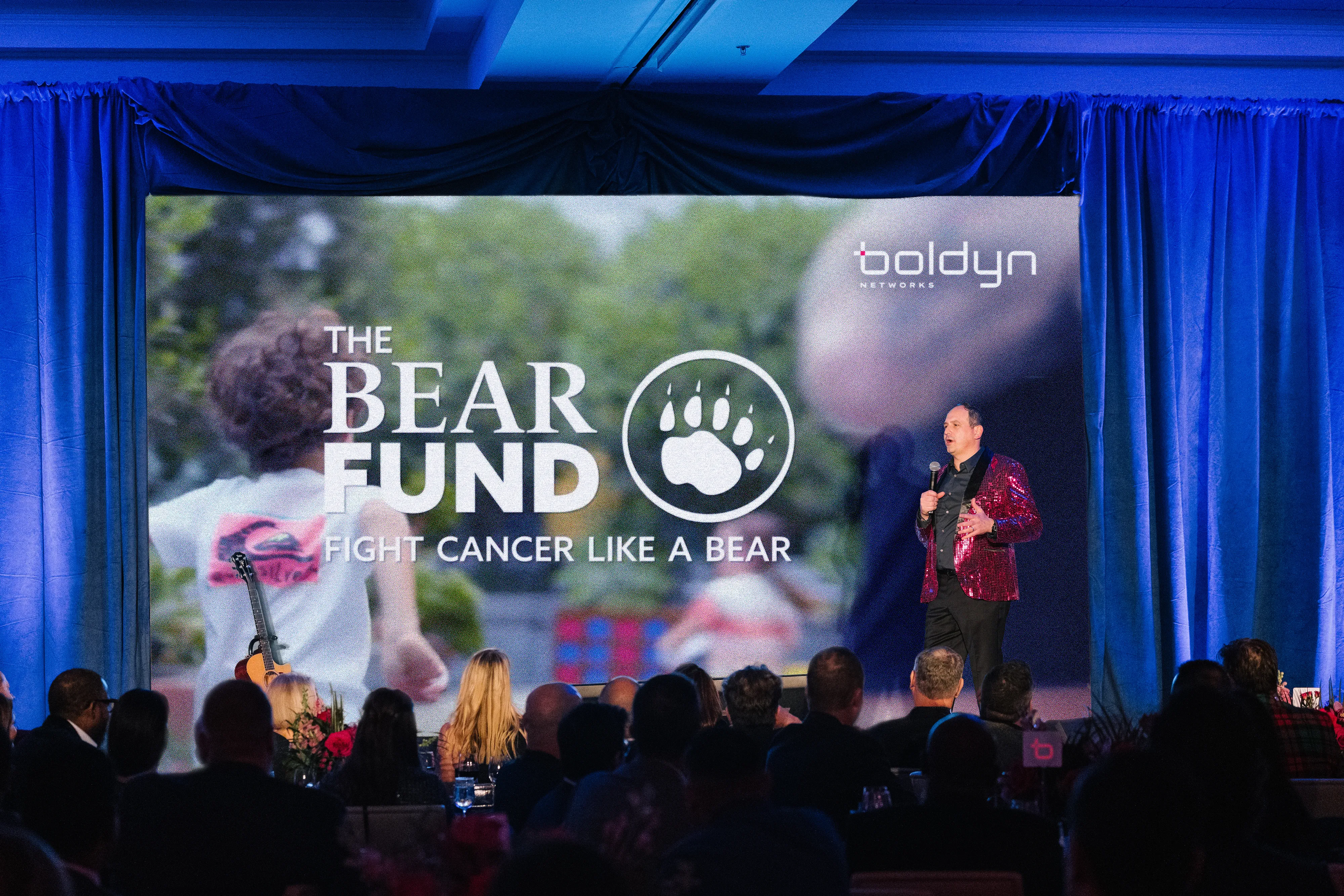 Man speaking at Bear Fund event