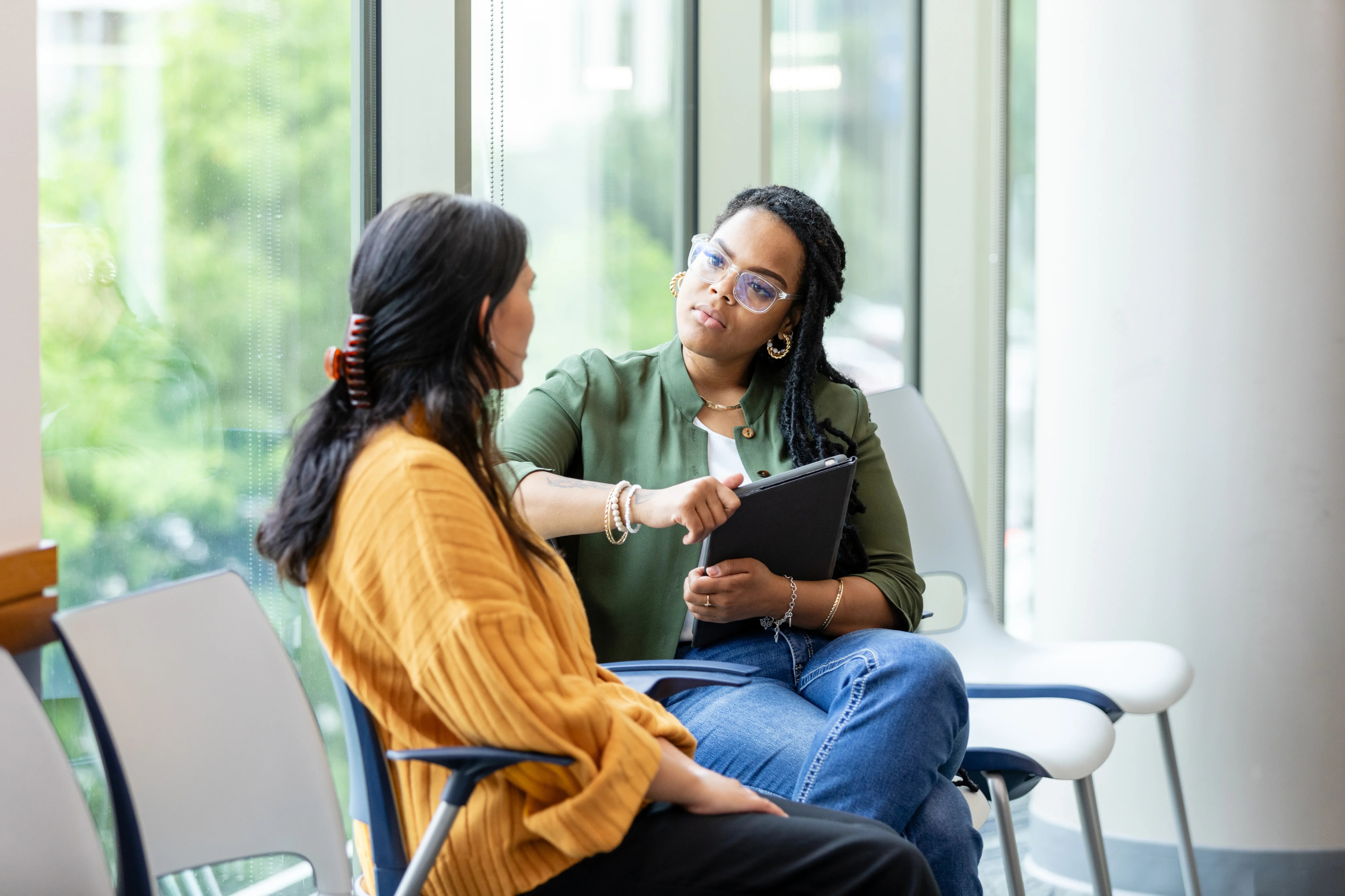 Two women sitting and talking in lobby 