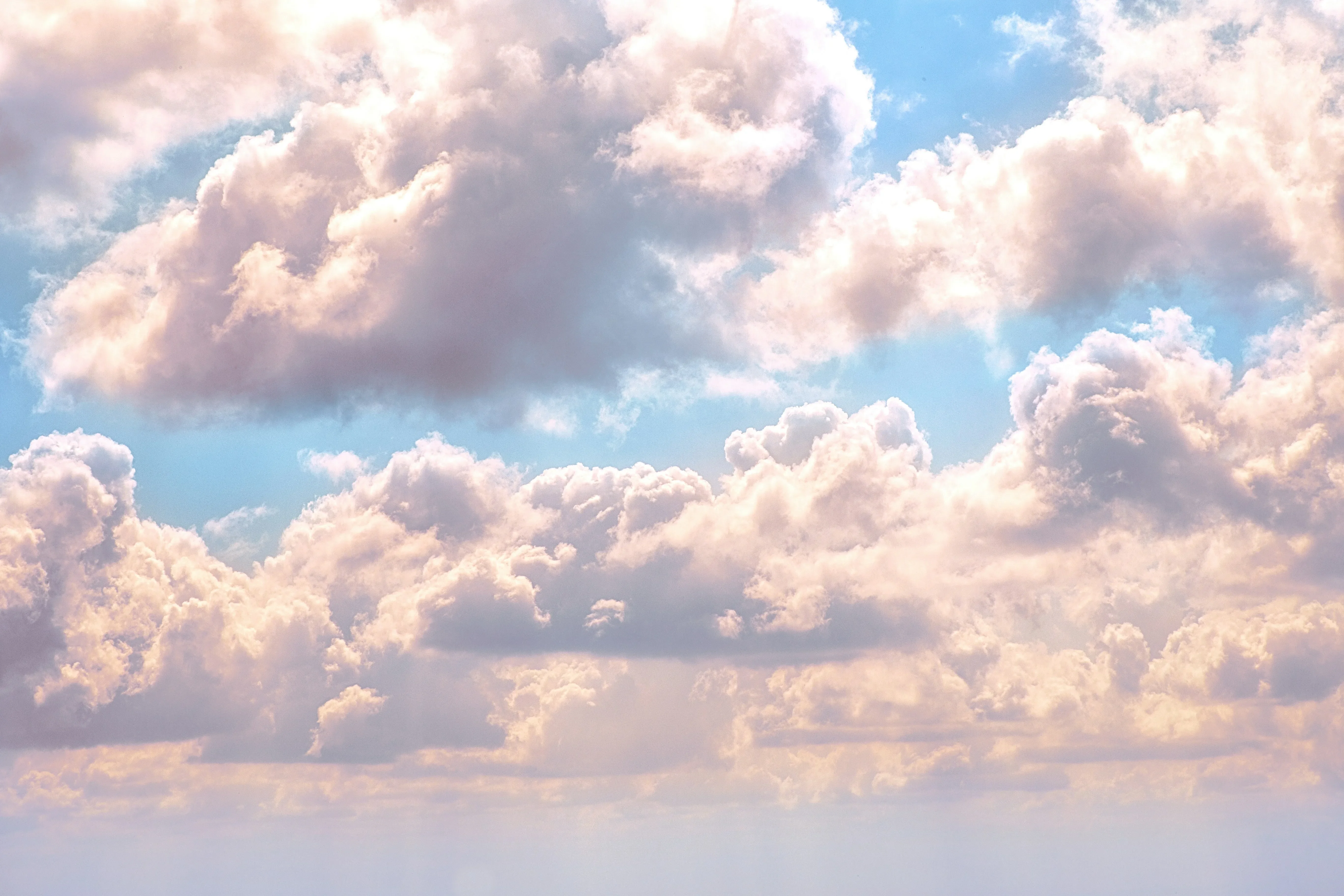Large puffy clouds scattered across a blue sky