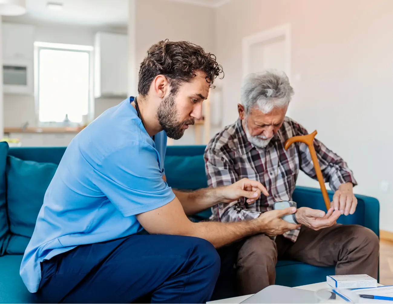 Younger man sitting with father on couch 