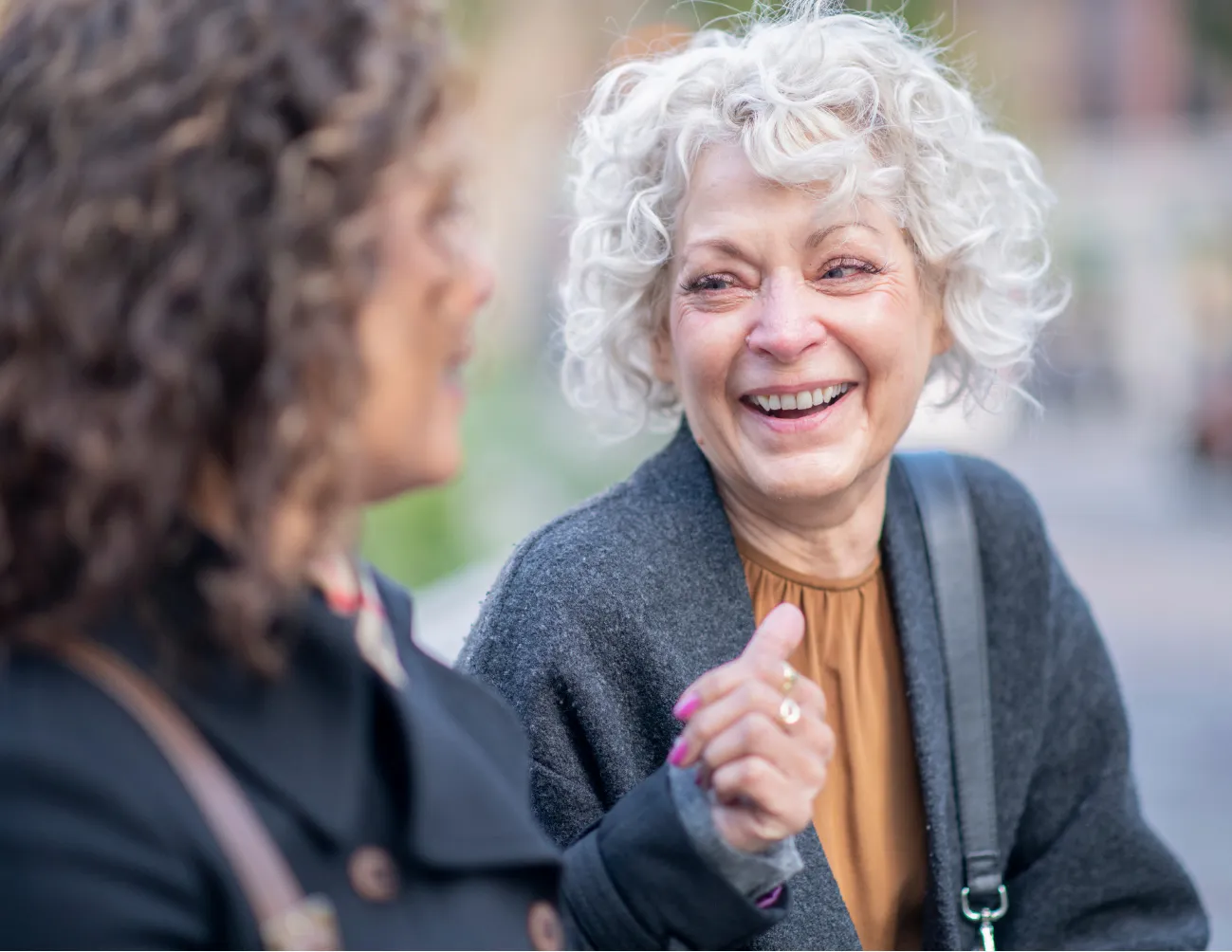 two women laughing outside