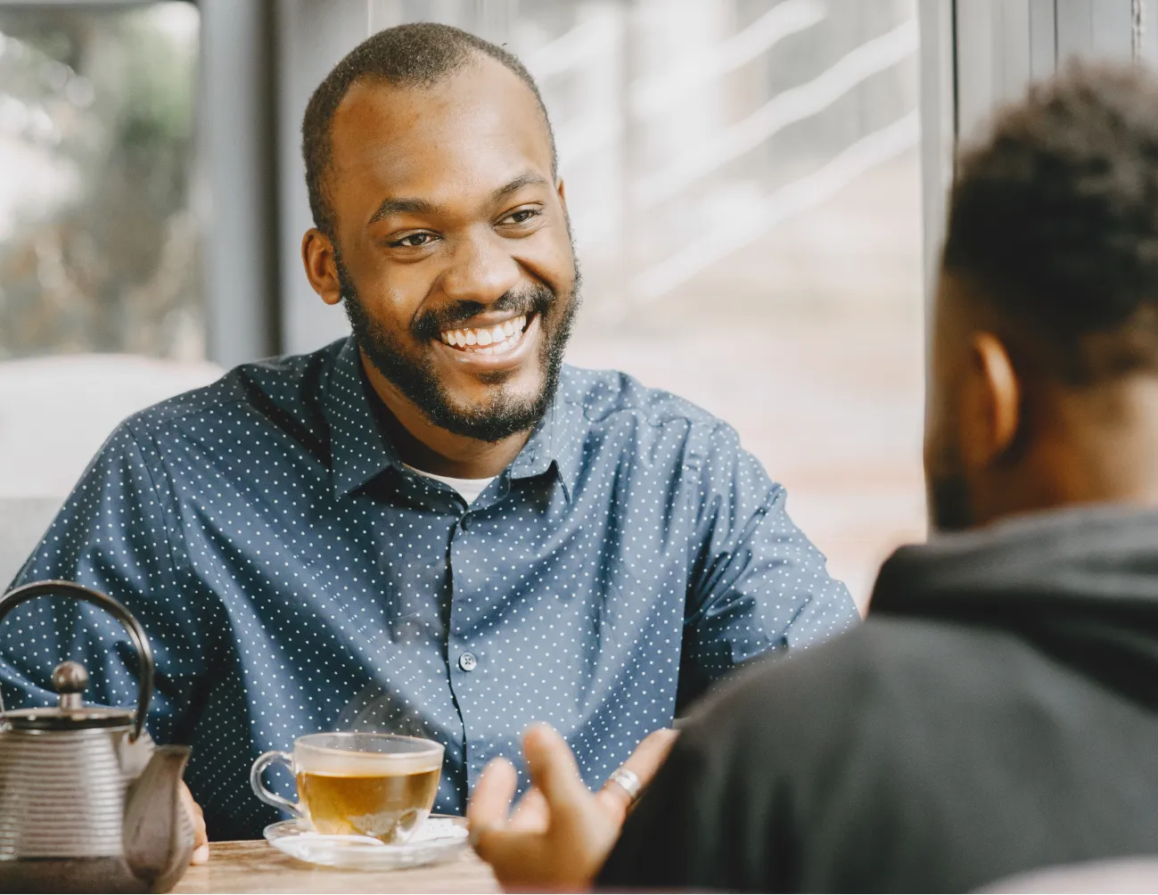 Two men talking at table