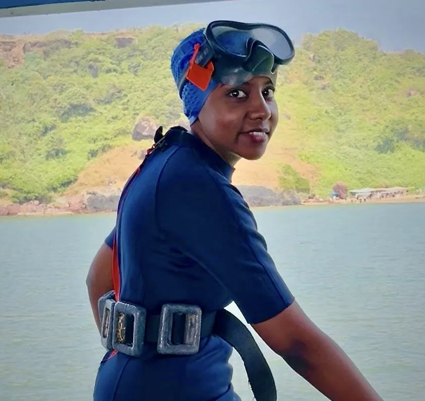 Krashnika wearing scuba diving gear gets ready to dive into water