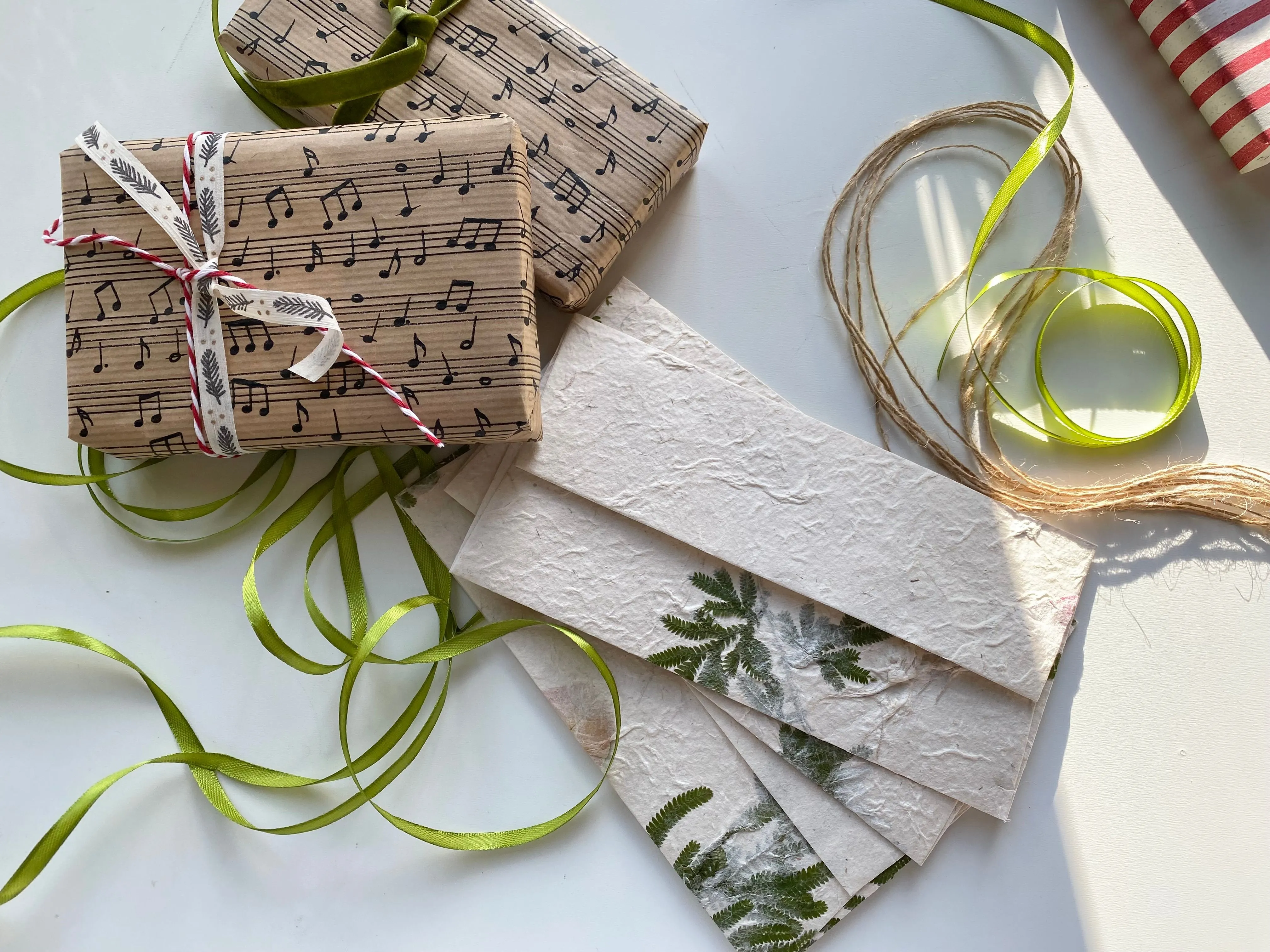 Gift boxes wrapped in paper decorated with music notes and ribbon