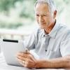 older white man looking at a tablet