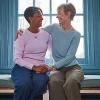 two older women embracing on window seat