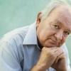 Portrait of an older balding white man who appears to be sad