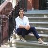 Young Asian woman smiling on the front steps