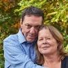 older white couple smiling softly and embracing outside