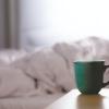 Green ceramic mug on nightstand