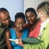 black family (father, mother, girl) with social worker