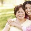 Mom and daughter hugging and smiling