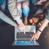 family signing onto laptop to help a loved one