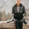 young white woman sitting outside with laptop