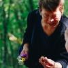 grandmother picks flowers with her granddaughter