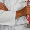 doctor with arms folded across his chest