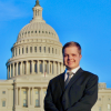 Gus Robertson smiles in front of the U.S. Capitol.