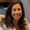 Marcia Donziger, CSC Chief Culture Office, smiles at her office desk