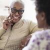 Two older black women smiling and laughing
