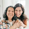 Two women smile at the camera