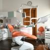 A sunny dentist office with an organ dental chair and white cabinets