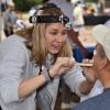 A volunteer doctor conducts a visual exam at a screening event hosted by the Head and Neck Cancer Alliance